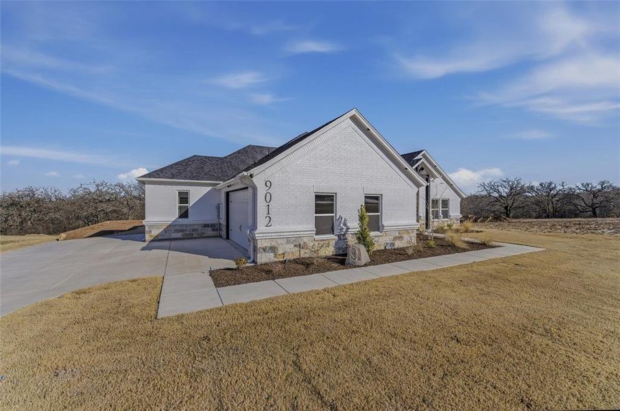 Front exterior of a new home in , Springtown, TX, highlighting curb appeal (Image 17).