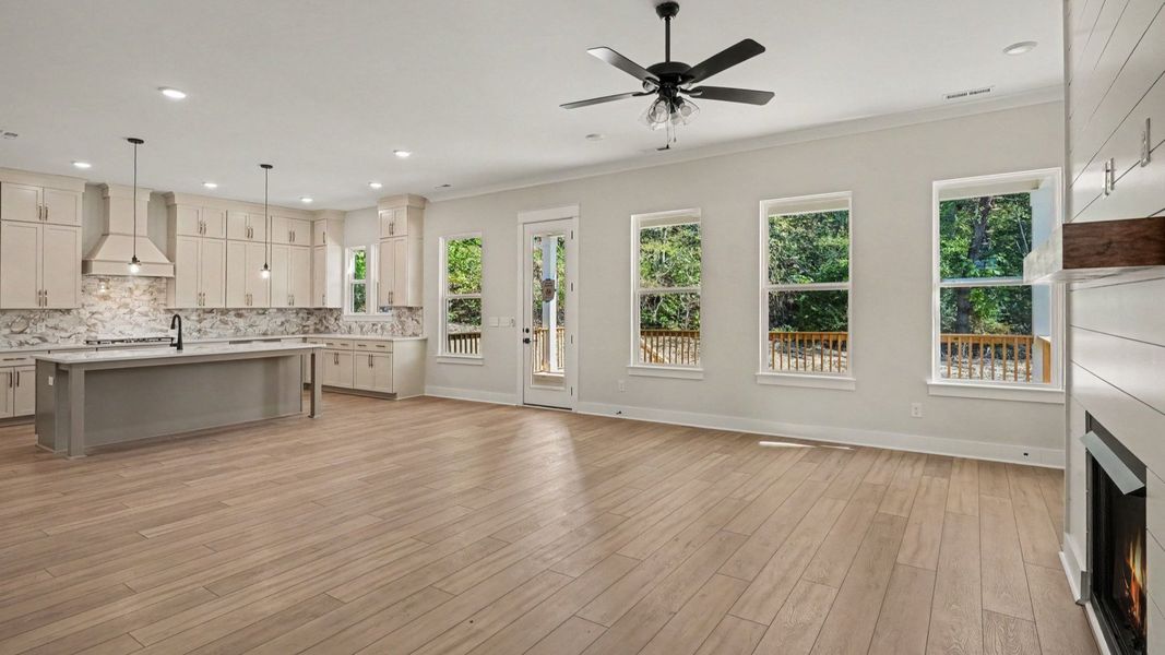 Open concept living area next to kitchen and dining areas Open concept living area next to kitchen and dining areas