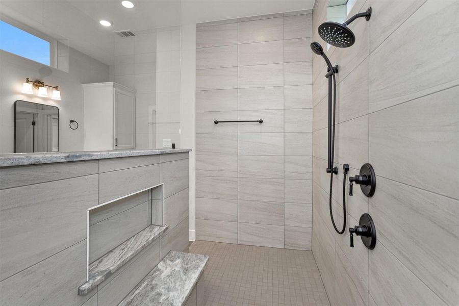 Enjoy plenty of elbow room in this expansive walk-in shower, thoughtfully designed to provide both comfort and luxury. With generous space to move freely, the layout enhances the spa-like feel while maintaining a sleek, modern look. This oversized shower offers the perfect blend of functionality and relaxation for your daily routine.