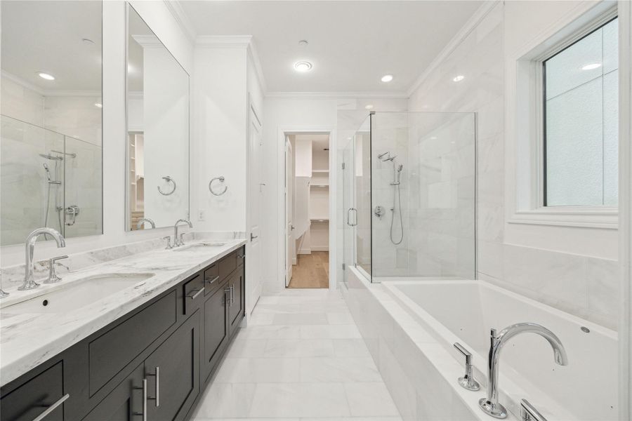 Primary bath is has extended vanity with dual sinks, separate soaking tub, and oversized shower with bench seat, all clad in gorgeous natural stone, as in this previous build. Primary bath is has extended vanity with dual sinks, separate soaking tub, and oversized shower with bench seat, all clad in gorgeous natural stone, as in this previous build.