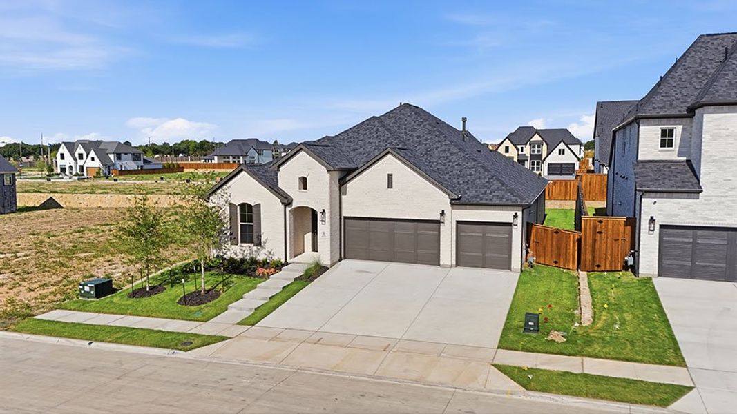 Front exterior of a new home in Custer Ridge Estates, Allen, TX, highlighting curb appeal (Image 25). Front exterior of a new home in Custer Ridge Estates, Allen, TX, highlighting curb appeal (Image 25).