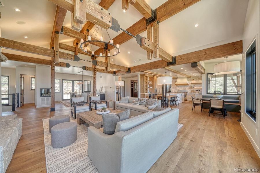 A vaulted great room anchors the home with dramatic timber trusses and a floor-to-ceiling Colorado stone fireplace. A vaulted great room anchors the home with dramatic timber trusses and a floor-to-ceiling Colorado stone fireplace.