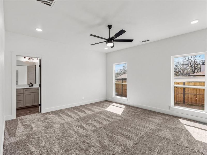 Unfurnished bedroom featuring recessed lighting, carpet, visible vents, and a sink