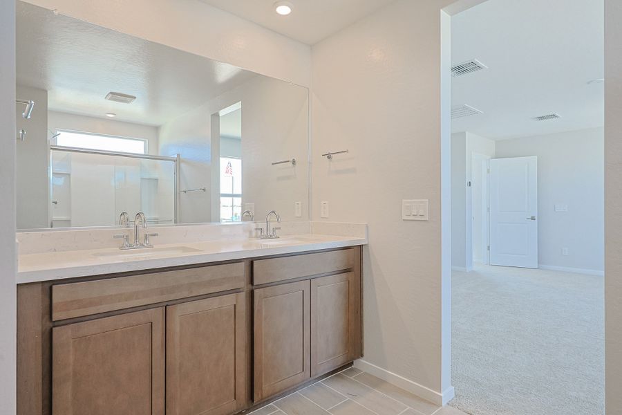 A bathroom with a large mirror. A bathroom with a large mirror.