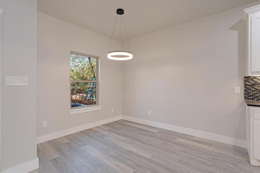 Unfurnished dining area featuring light hardwood / wood-style flooring