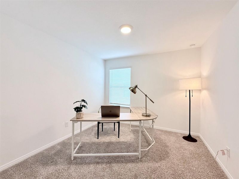 Carpeted office with baseboards Carpeted office with baseboards