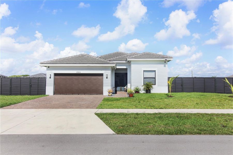 Front exterior of a new home in , Homestead, FL, highlighting curb appeal (Image 2).