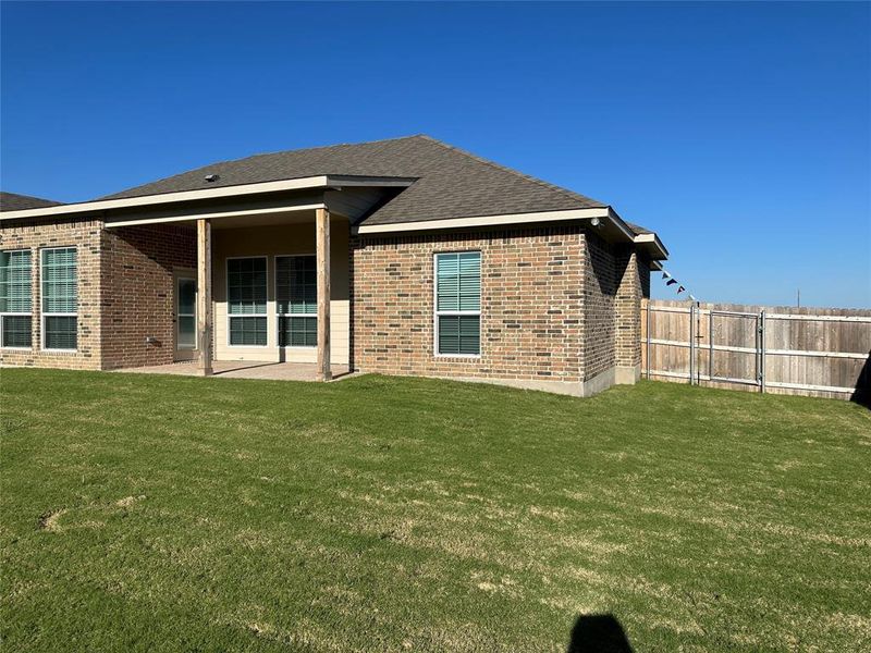 Expansive grassy yard with full privacy fencing Expansive grassy yard with full privacy fencing