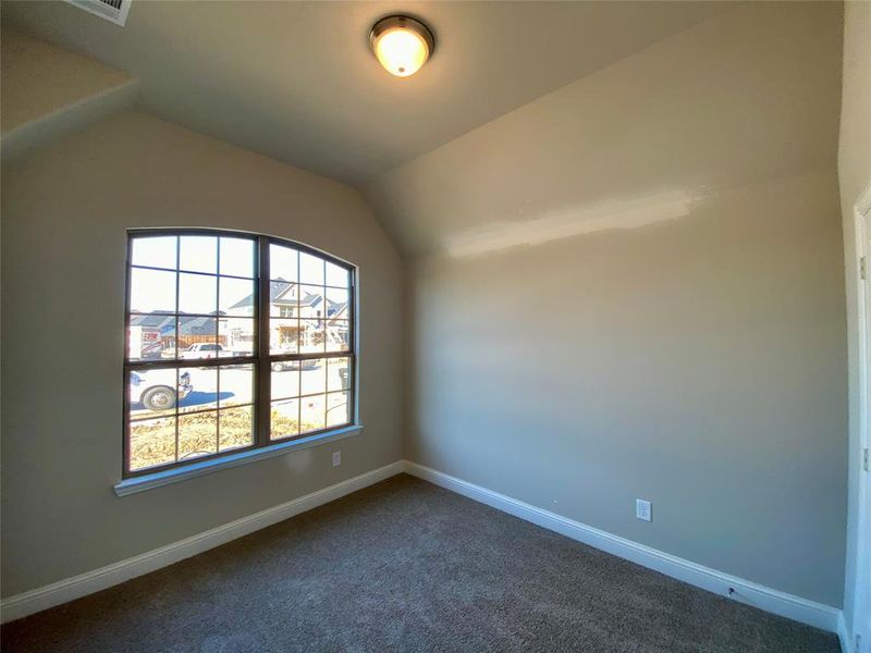 Bed 2 with large window and vaulted ceiling