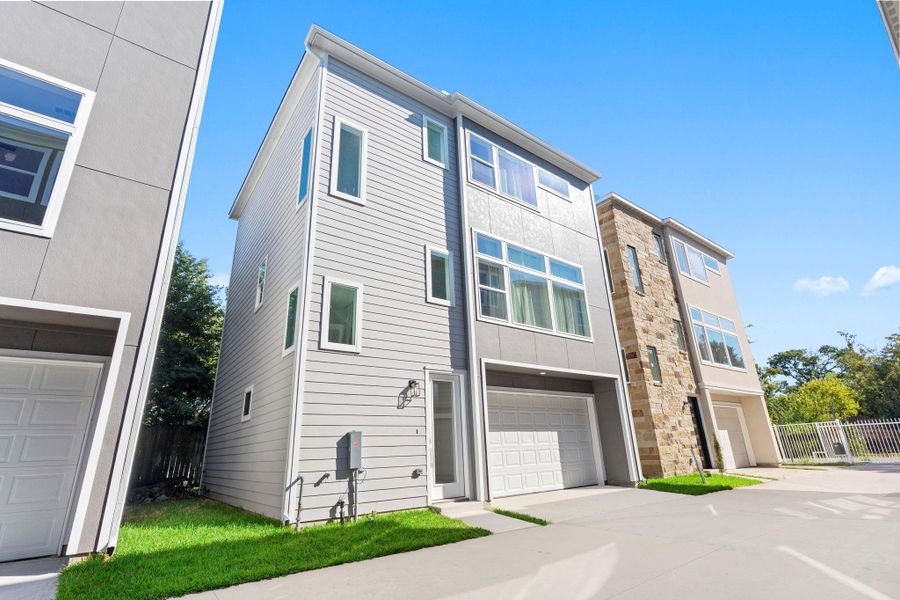 Sleek front elevation showcasing contemporary design and a spacious 2-car garage. Sleek front elevation showcasing contemporary design and a spacious 2-car garage.