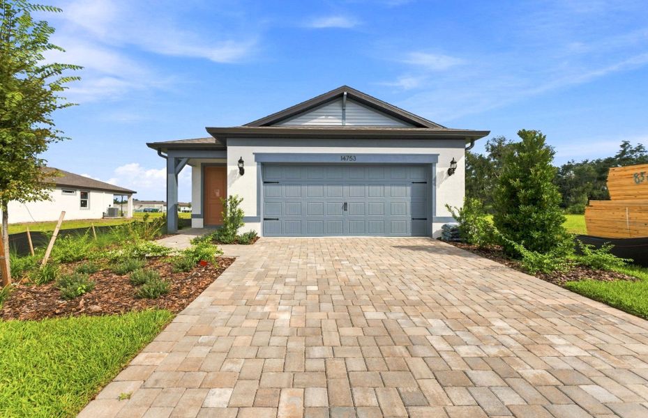 Front exterior of a new home in Del Webb Sunchase, Parrish, FL, highlighting curb appeal (Image 18).