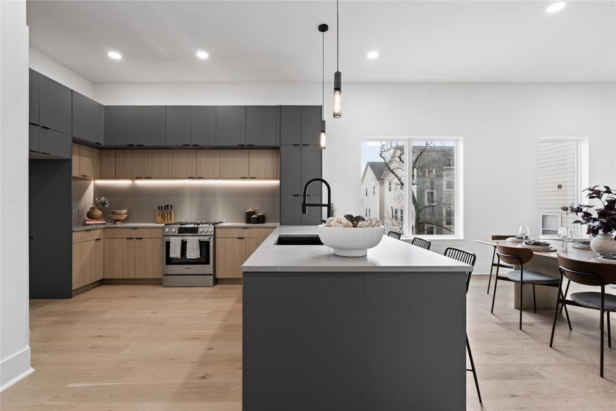 This kitchen is a masterclass in balance—striking the perfect harmony between form and utility. Floor-to-ceiling custom cabinetry maximizes vertical storage without compromising the room’s minimalist elegance, while the matte black detailing offers a grounded, contemporary edge. Every line feels intentional, every finish bespoke—a kitchen designed for both culinary performance and visual impact