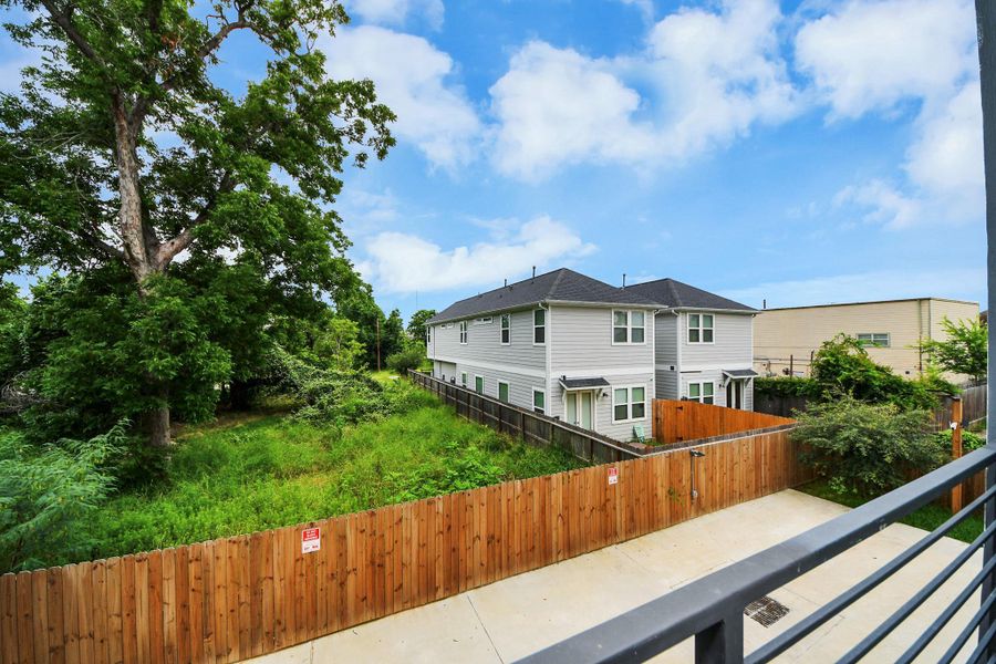 This photo shows a suburban area with a fenced yard, lush greenery, and a two-story home in the background, offering a peaceful and private setting. This photo shows a suburban area with a fenced yard, lush greenery, and a two-story home in the background, offering a peaceful and private setting.