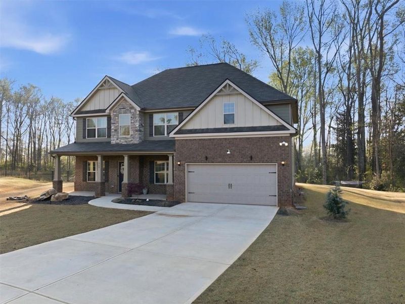 Front exterior of a new home in Nine Oaks, Locust Grove, GA, highlighting curb appeal (Image 25).
