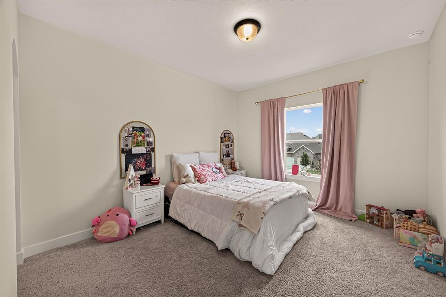 The secondary bedroom is spacious and filled with natural light. The secondary bedroom is spacious and filled with natural light.