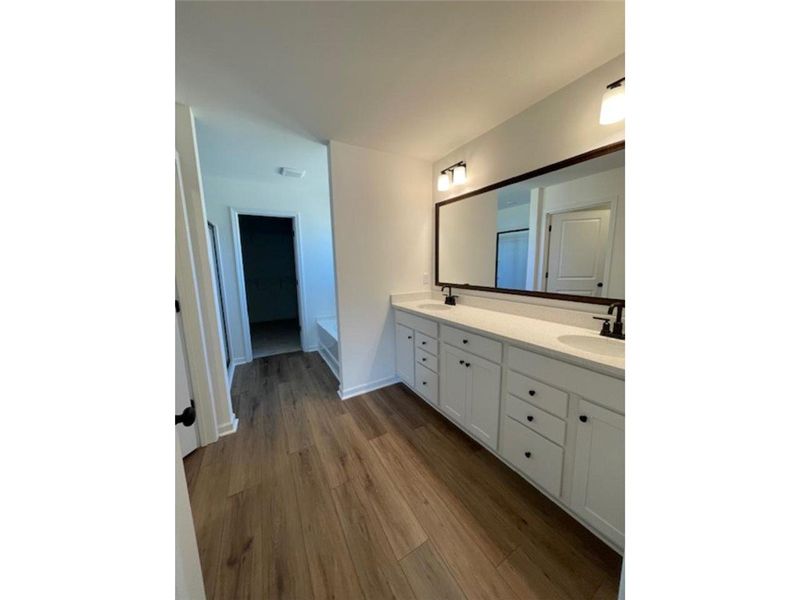 This spacious bathroom offers elegant dual vanitie