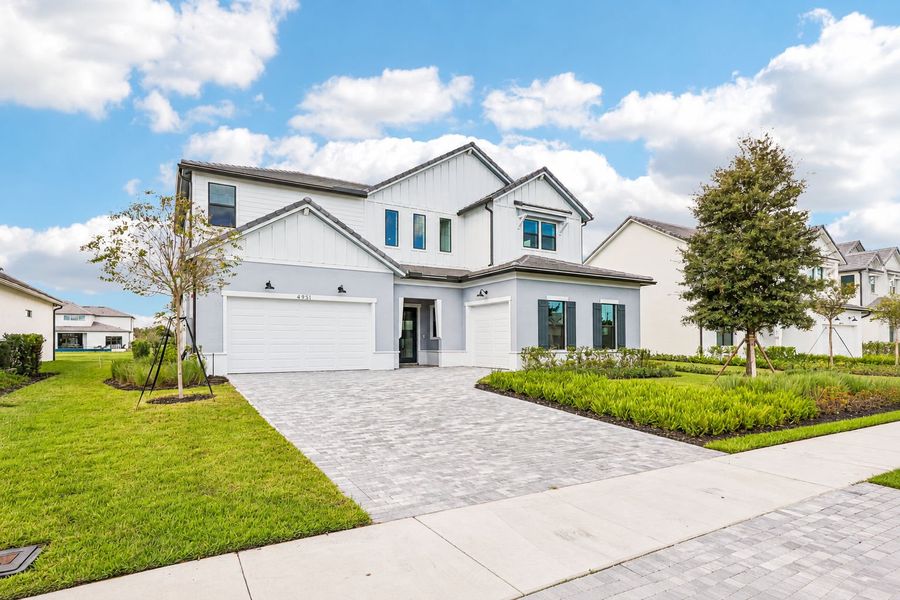 Front exterior of a new home in Marigold, Davie, FL, highlighting curb appeal (Image 27). Front exterior of a new home in Marigold, Davie, FL, highlighting curb appeal (Image 27).