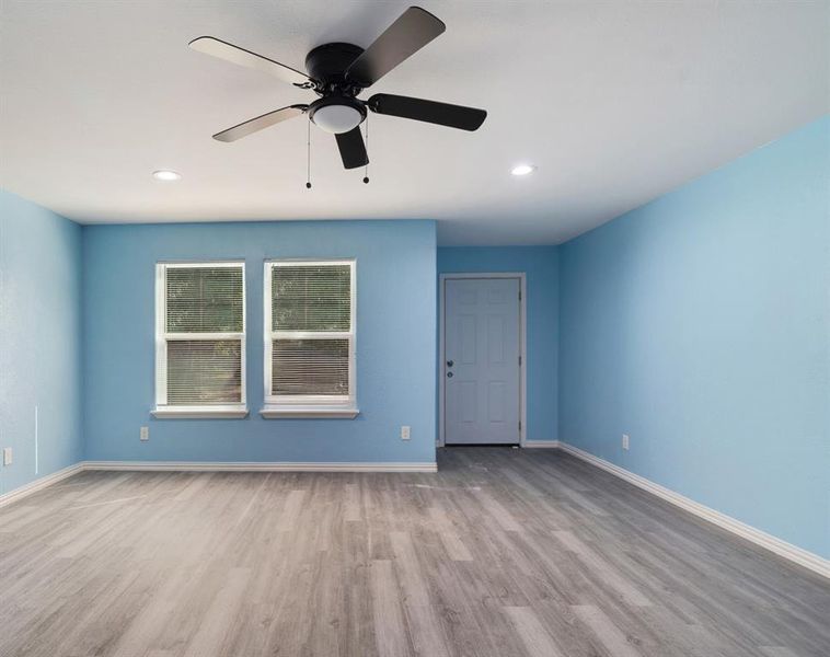 Empty room featuring light wood finished floors, recessed lighting, and ceiling fan Empty room featuring light wood finished floors, recessed lighting, and ceiling fan