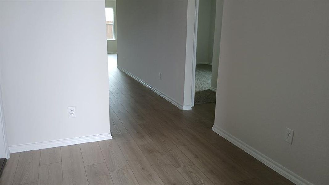 Wood-finish flooring throughout, featuring crisp white baseboards and neutral wall tones Wood-finish flooring throughout, featuring crisp white baseboards and neutral wall tones
