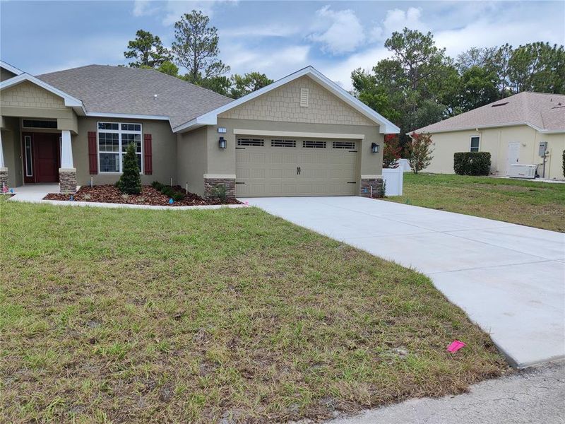Front exterior of a new home in Sugarmill Woods, Homosassa, FL, highlighting curb appeal (Image 2). Front exterior of a new home in Sugarmill Woods, Homosassa, FL, highlighting curb appeal (Image 2).