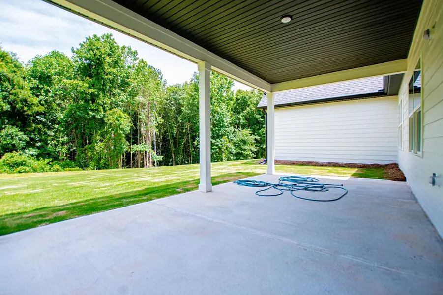 Exterior details and patio area of a home in WOODMONT RESERVE, Roopville (Image 50).