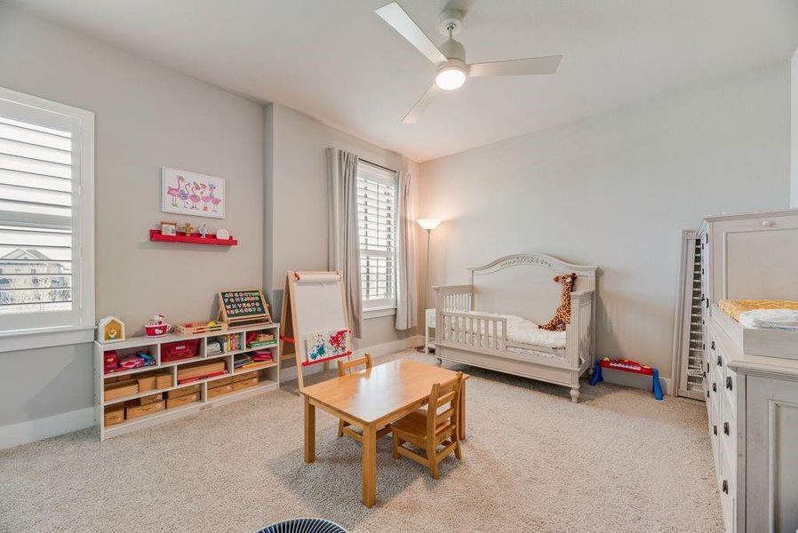 Bedroom with light carpet and ceiling fan