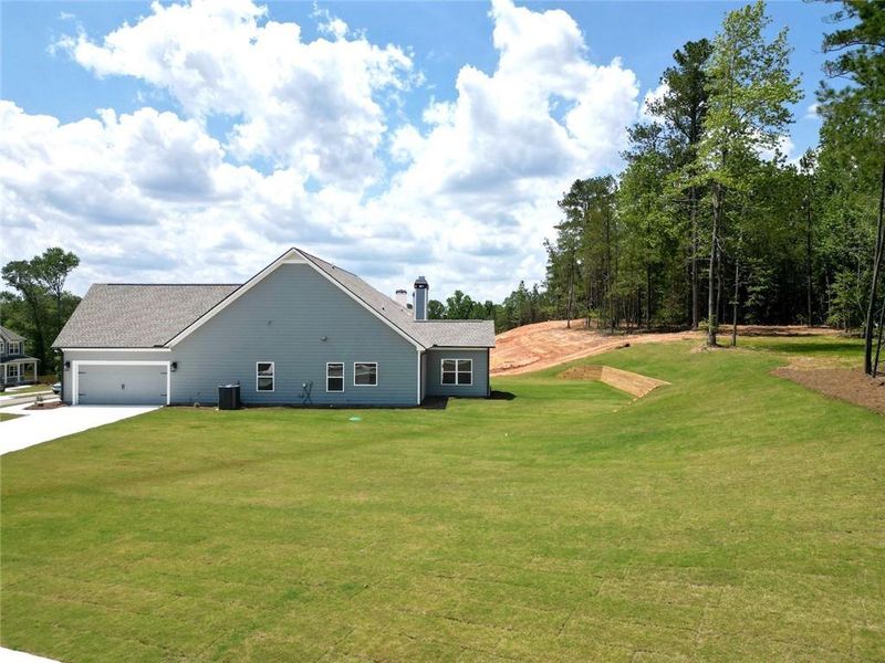 Front exterior of a new home in Woodland Hills, Loganville, GA, highlighting curb appeal (Image 2). Front exterior of a new home in Woodland Hills, Loganville, GA, highlighting curb appeal (Image 2).