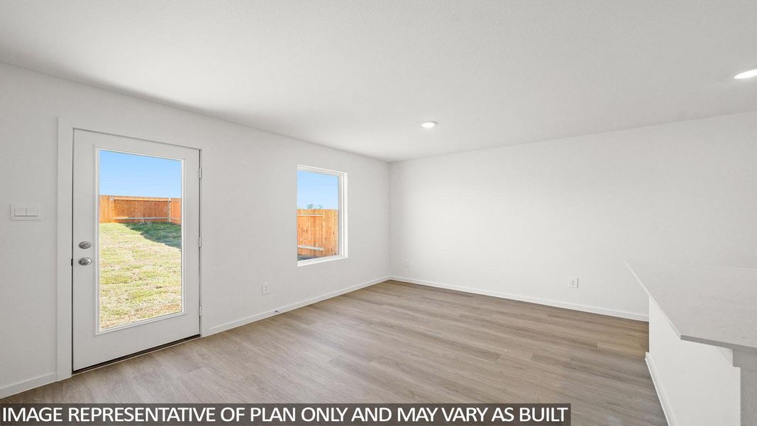 A versatile living space with light wood flooring offers views of the enclosed yard, perfect for customization. A versatile living space with light wood flooring offers views of the enclosed yard, perfect for customization.