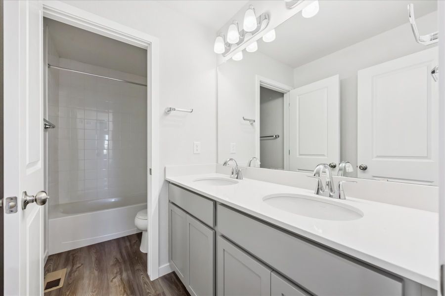 A bathroom with a sink and a shower unit.