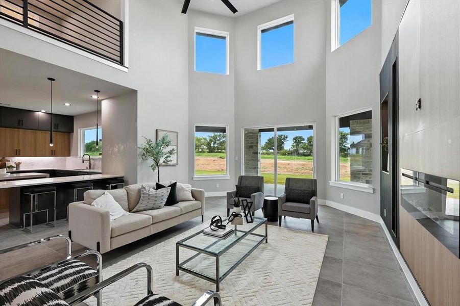 Living room featuring a high ceiling and ceiling fan