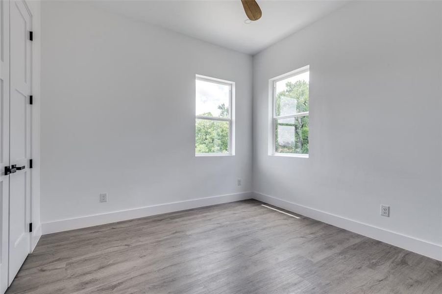 Empty room featuring ceiling fan and light hardwood / wood-style floors