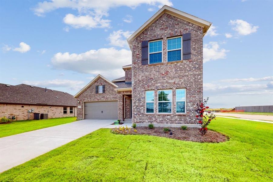 Front exterior of a new home in Prairie Ridge at Goodland, Venus, TX, highlighting curb appeal (Image 21).