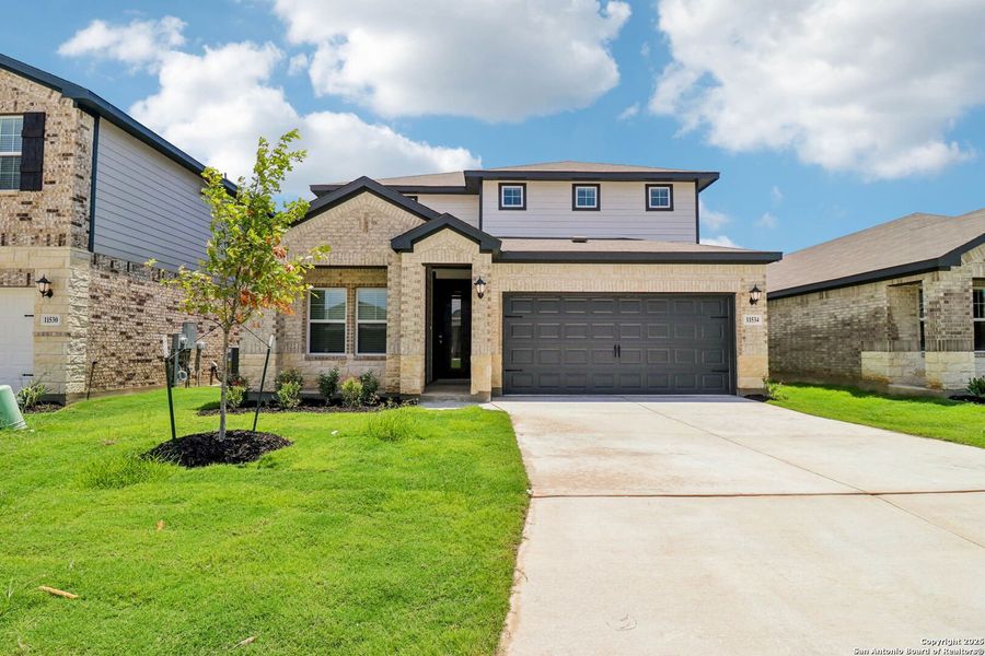 Front exterior of a new home in Sagebrooke - Premier Series, San Antonio, TX, highlighting curb appeal (Image 22). Front exterior of a new home in Sagebrooke - Premier Series, San Antonio, TX, highlighting curb appeal (Image 22).