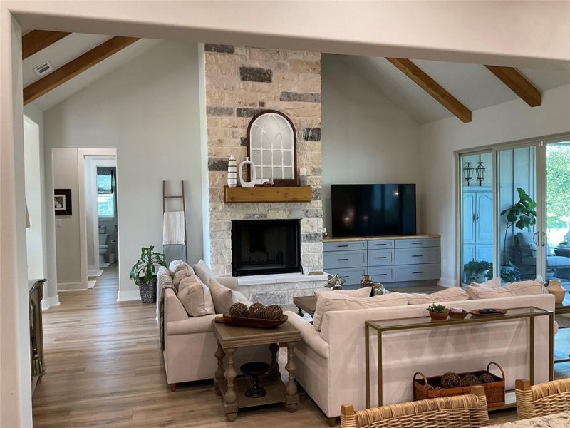 floor to ceiling wood burning fireplace with gas connection, family room has cathedral vaulted ceiling with wood beams