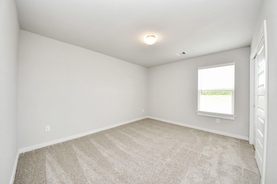 Generously sized secondary bedrooms featuring spacious closets, soft and inviting carpeting underfoot, large windows allowing plenty of natural light, and the added touch of privacy blinds for your personal retreat. Sample photo of completed home with similar floor plan. Actual colors and selections may vary. Generously sized secondary bedrooms featuring spacious closets, soft and inviting carpeting underfoot, large windows allowing plenty of natural light, and the added touch of privacy blinds for your personal retreat. Sample photo of completed home with similar floor plan. Actual colors and selections may vary.