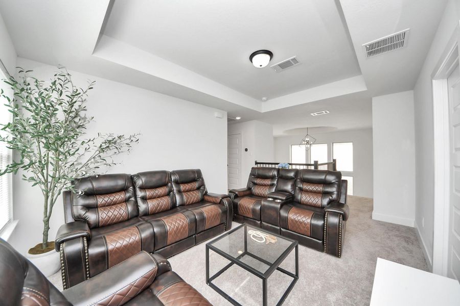 This spacious living room features modern leather seating, a glass coffee table, and soft carpeting. A large window allows for natural light, and the open layout leads to a dining area, enhancing the airy feel. This spacious living room features modern leather seating, a glass coffee table, and soft carpeting. A large window allows for natural light, and the open layout leads to a dining area, enhancing the airy feel.