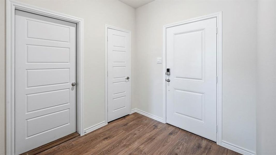 Doorway to outside featuring wood finished floors Doorway to outside featuring wood finished floors