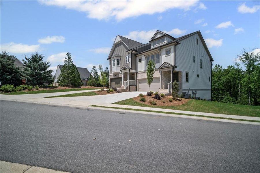 Front exterior of a new home in The Retreat at River Green, Canton, GA, highlighting curb appeal (Image 21). Front exterior of a new home in The Retreat at River Green, Canton, GA, highlighting curb appeal (Image 21).