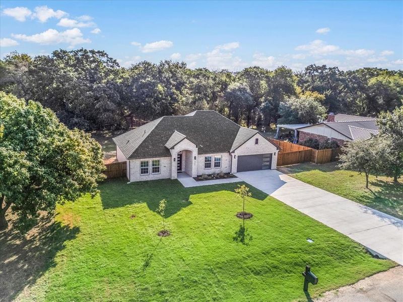 View of front of property featuring a front lawn and a garage