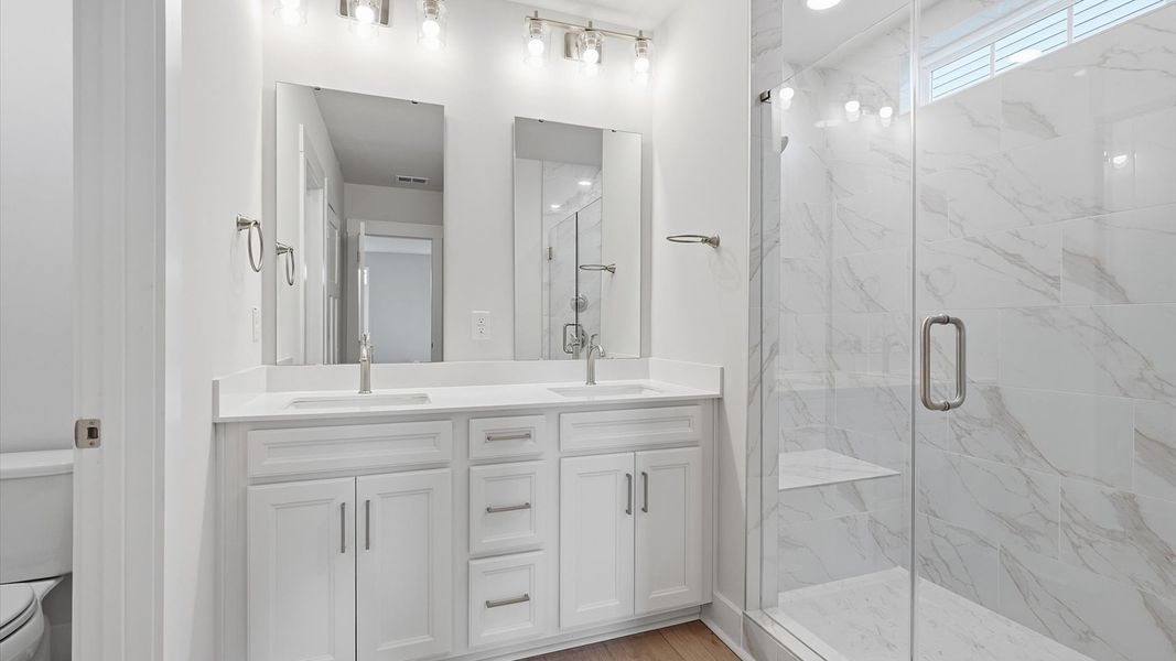 Tasteful primary bath with modern finishes, a walk-in shower, and thoughtful double vanity layout in Moore, SC Tasteful primary bath with modern finishes, a walk-in shower, and thoughtful double vanity layout in Moore, SC