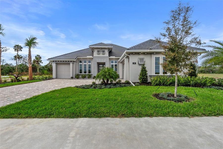 Front exterior of a new home in Veranda Bay, Flagler Beach, FL, highlighting curb appeal (Image 21). Front exterior of a new home in Veranda Bay, Flagler Beach, FL, highlighting curb appeal (Image 21).