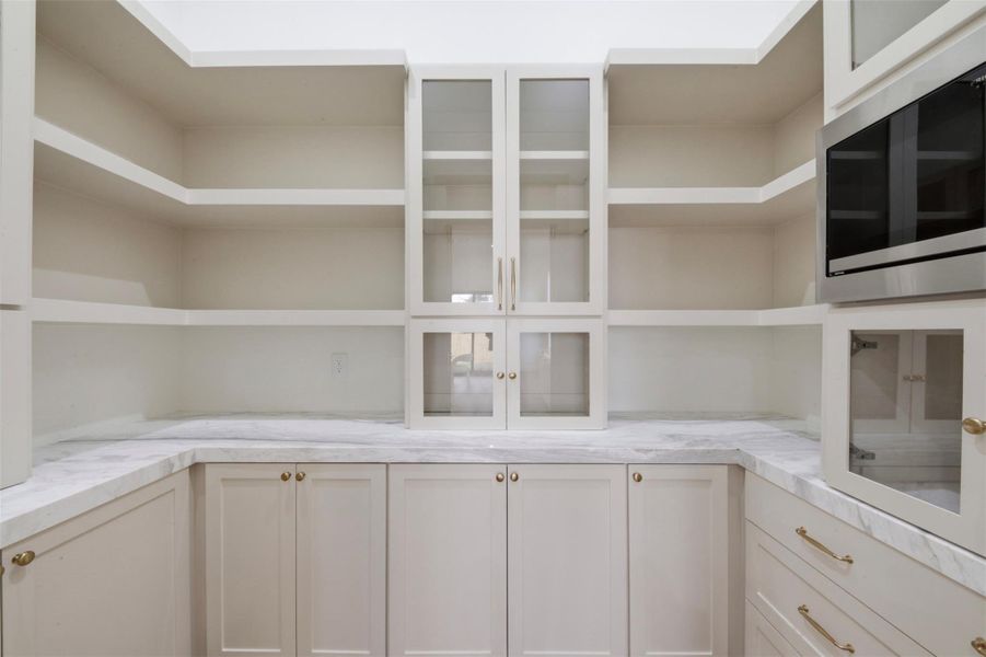 Oversized Walk in Pantry with Marble Counter Tops and Extensive Storage