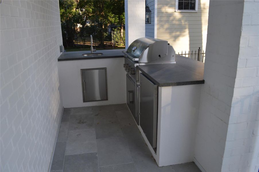 Summer kitchen off the back patio area. Coyote grill, outdoor refrigerator, and sink area. Summer kitchen off the back patio area. Coyote grill, outdoor refrigerator, and sink area.