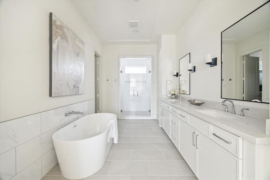 Spa Inspired Retreat – This primary bath features double vanities, quartz count tops, framed mirrors flanked by wall sconces adorned by a well-appointed bathroom chandelier.  Bring your night to a perfect close in the stand-alone soaking tub.