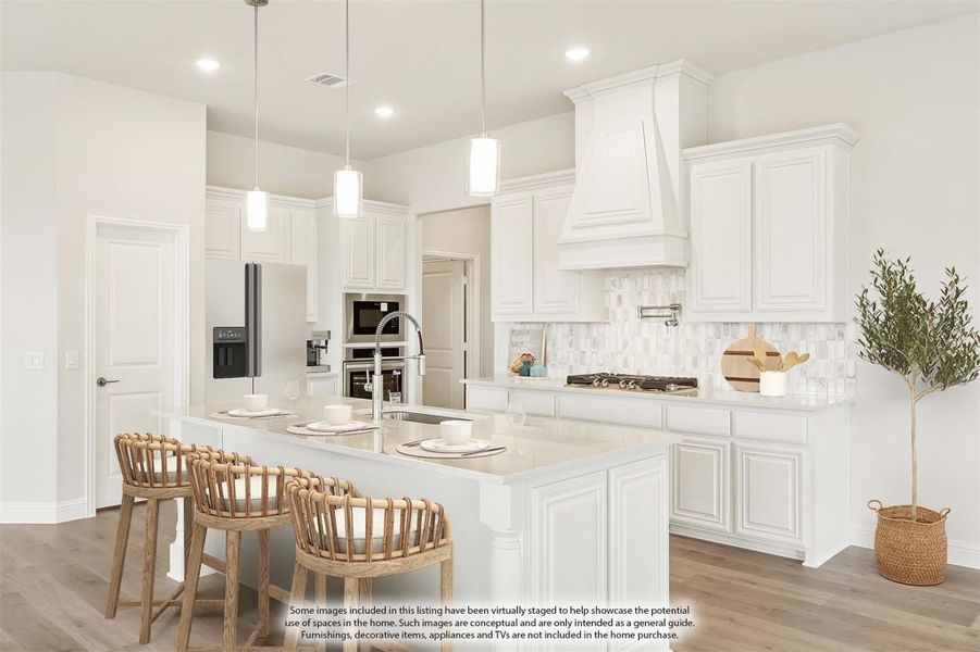 White kitchen with large island, pendant lights, tile backsplash, and stainless steel appliances