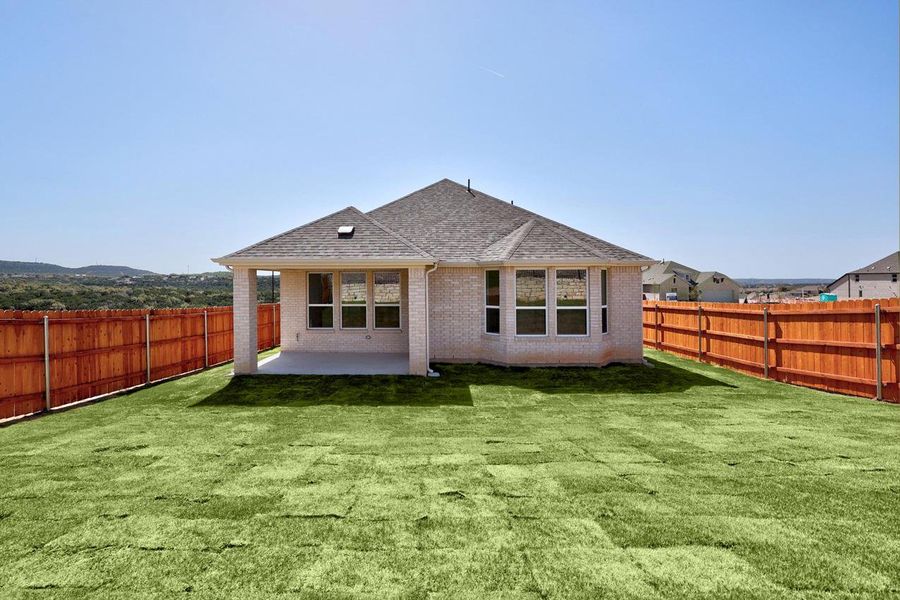 Back of property with roof with shingles, brick siding, a patio, and a fenced backyard