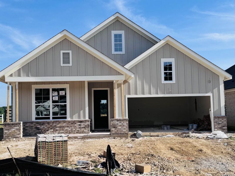 Single-story residence featuring light gray board-and-batten siding and white trim Single-story residence featuring light gray board-and-batten siding and white trim