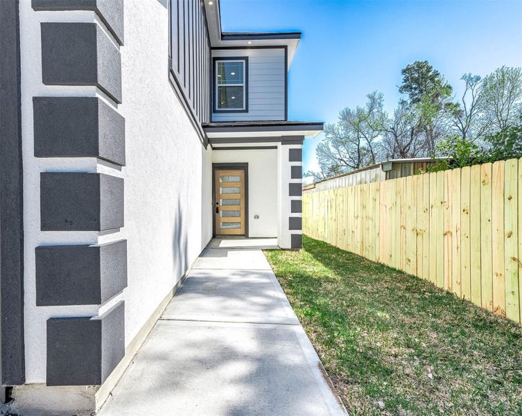 Follow the private side walkway to a contemporary entry featuring crisp stucco finishes and modern design details. Follow the private side walkway to a contemporary entry featuring crisp stucco finishes and modern design details.