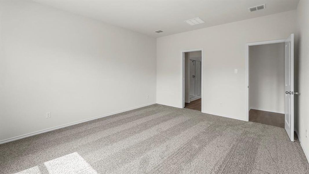 Spacious room featuring light gray carpet flooring, white walls, and white trim