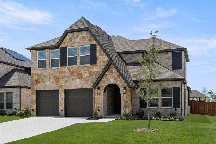 Front exterior of a new home in Valencia on The Lake, Little Elm, TX, highlighting curb appeal (Image 25). Front exterior of a new home in Valencia on The Lake, Little Elm, TX, highlighting curb appeal (Image 25).